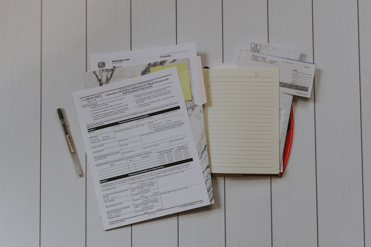 Business paperwork and a pen